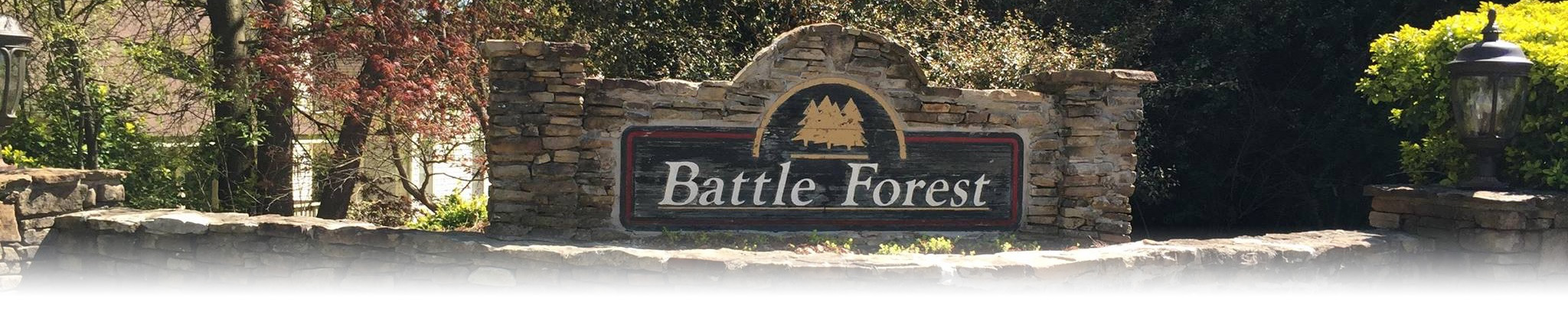 Photo of Battle Forest Entrance Sign, with greenery in the background.